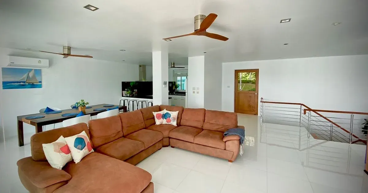 Spacious living room with comfortable sofas and stunning sea views.